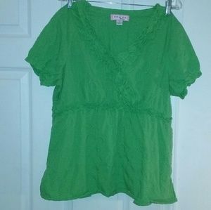 Koi brand top with ruffle detail and pockets